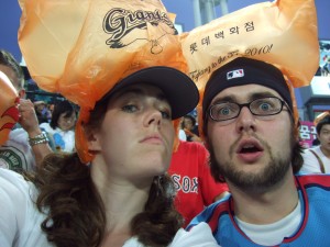 Britta and her brother, with their orange rally caps during the baseball game