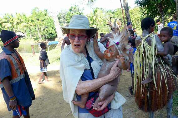 papua-new-guinea-tourist-holds-infant.jpg