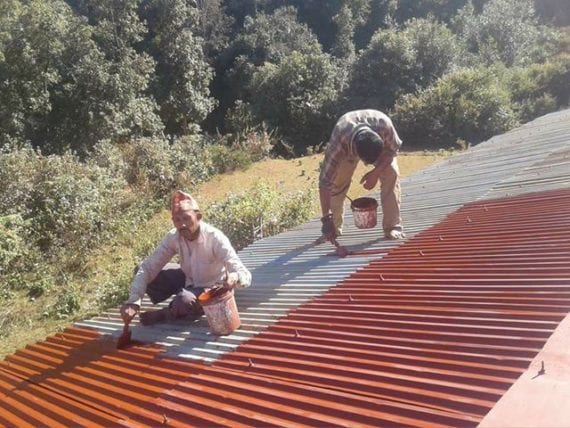 Men painting a roof