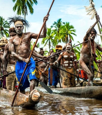 Group of Asmat people in a canoe