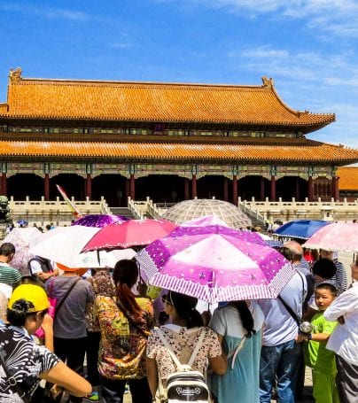 People with umbrellas near Forbidden City, China