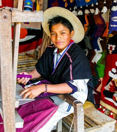 Person weaves textiles in Ecuador