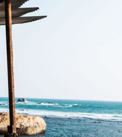 Man stands by ocean in Galle, Sri Lanka