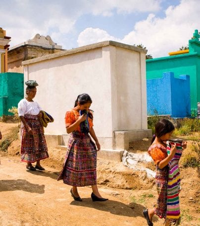 People walk through colorful Guatemala cemetery