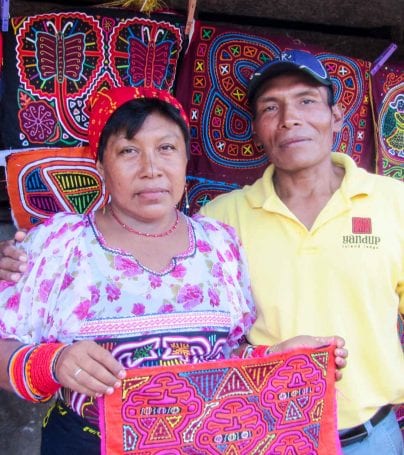 Man and woman hold colorful fabrics in Panama