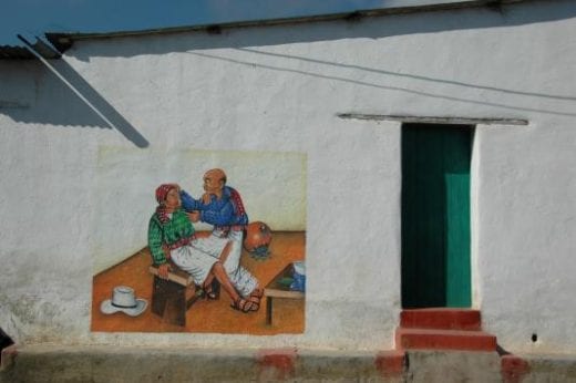 The exterior of house and shops in San Juan Atitlan are typically decorated with mural paintings.