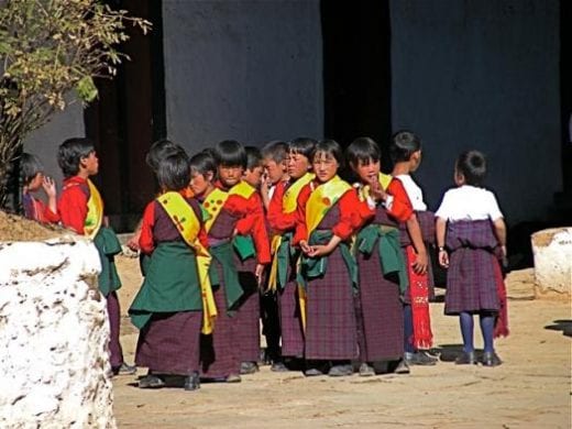 Bhutanese school children prepare to dance at the Crane Festival