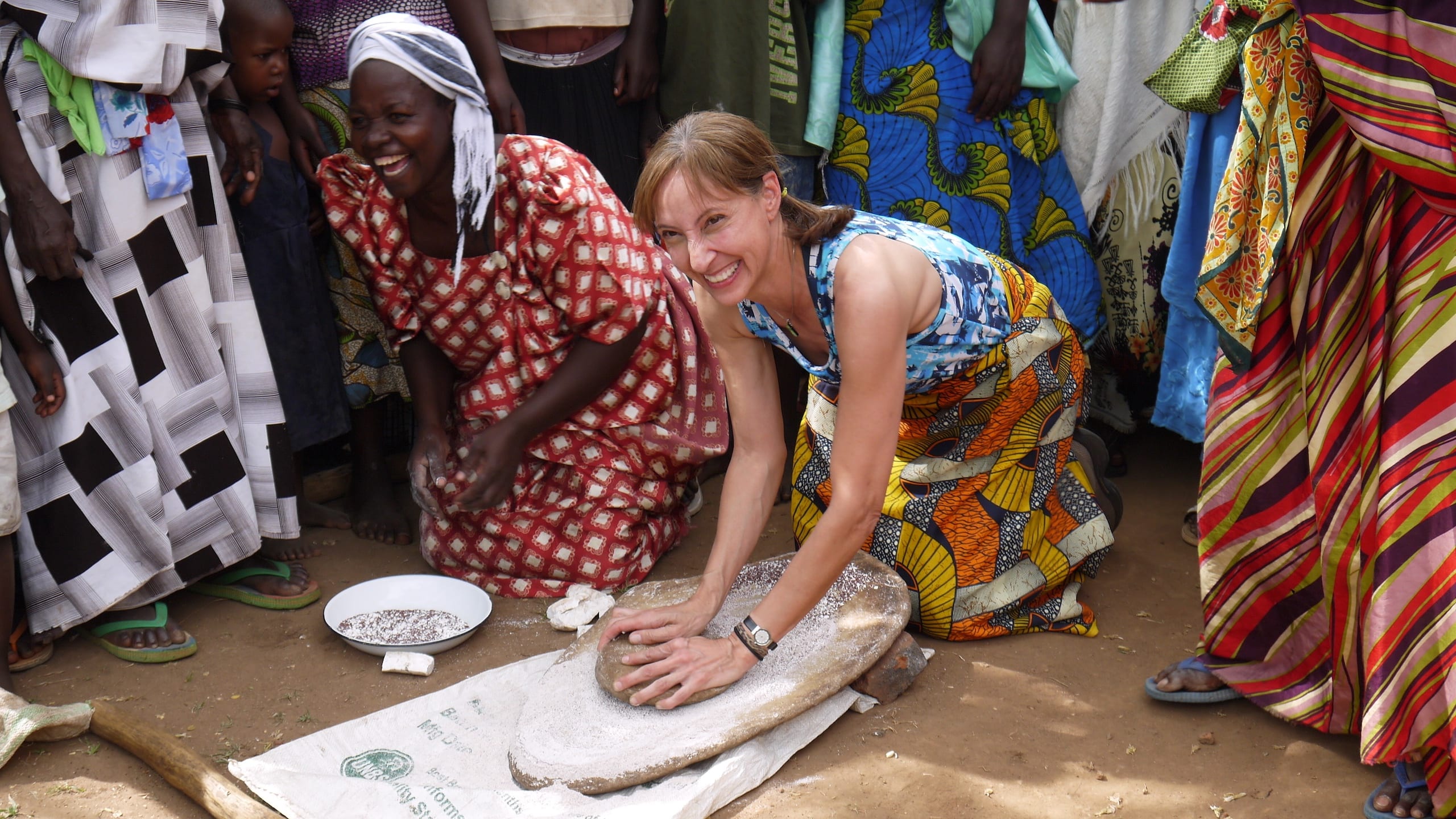 women in Uganda preparing dough
