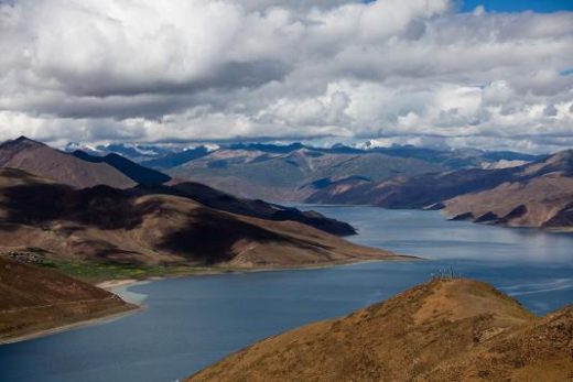 Pass the beautiful Yamdrok Lake