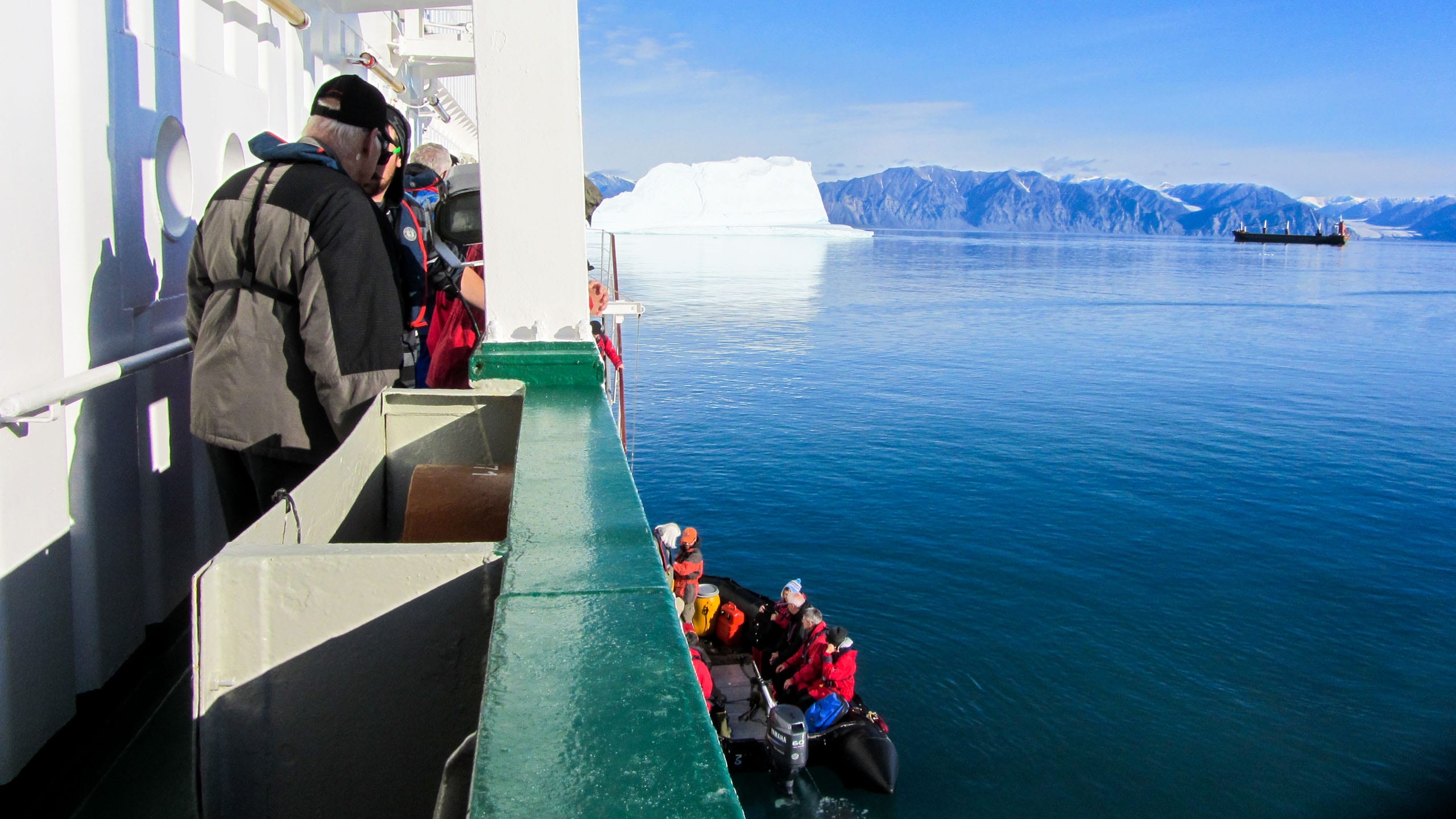 Travelers look at Arctic view from ship