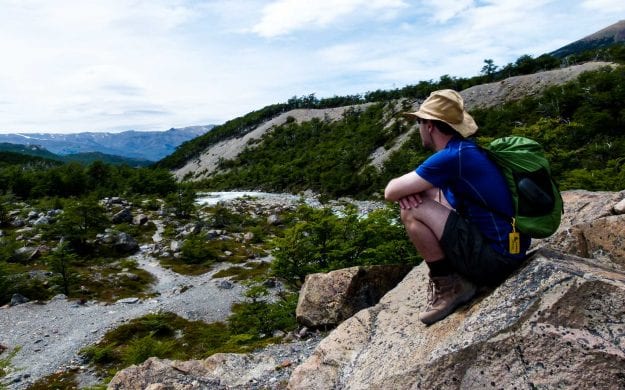 Hiker sits on Argentina rocks