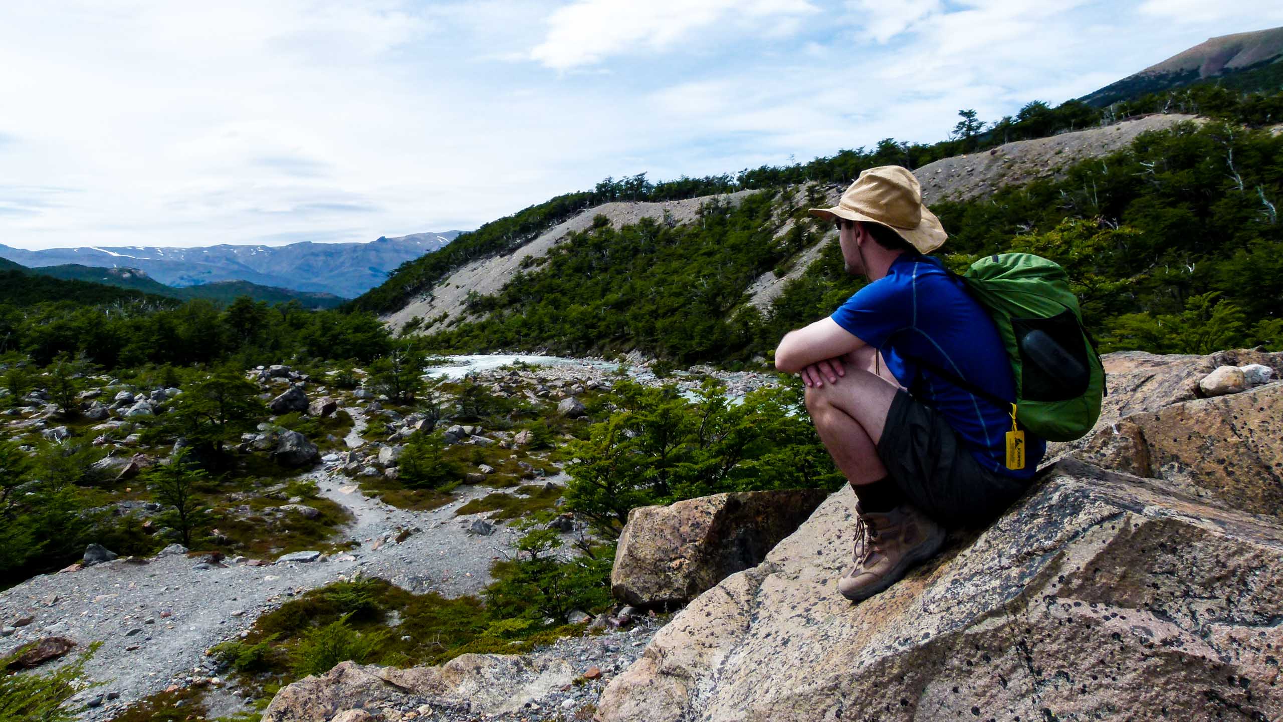 Hiker sits on Argentina rocks