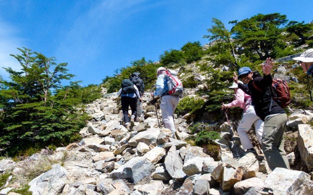 Hiking group climbs rocky trail in Argentina