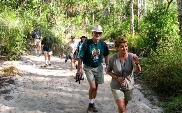 Travel group hikes in Australia forest