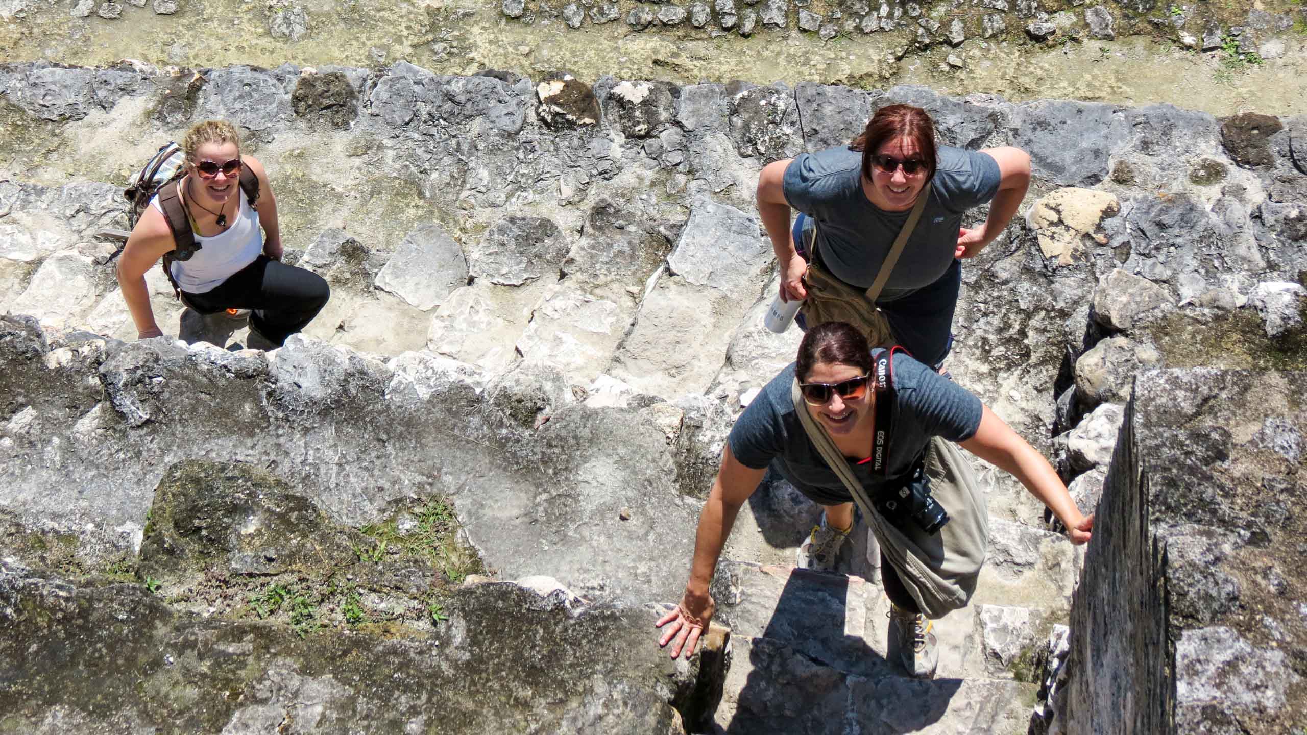 People climbing Belize temple ruins