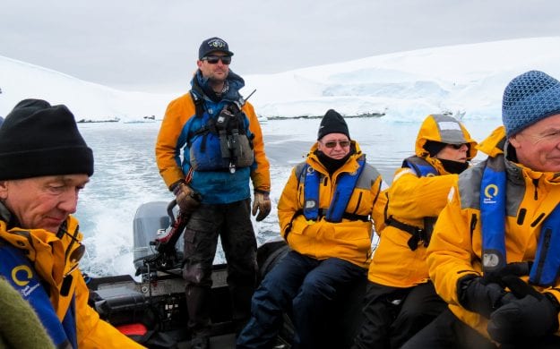 Group of travelers rides boat in Antarctica