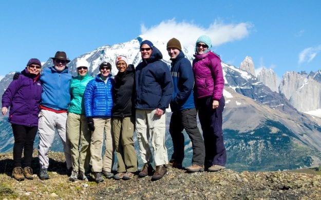 Group of travelers stand high in Chile mountains