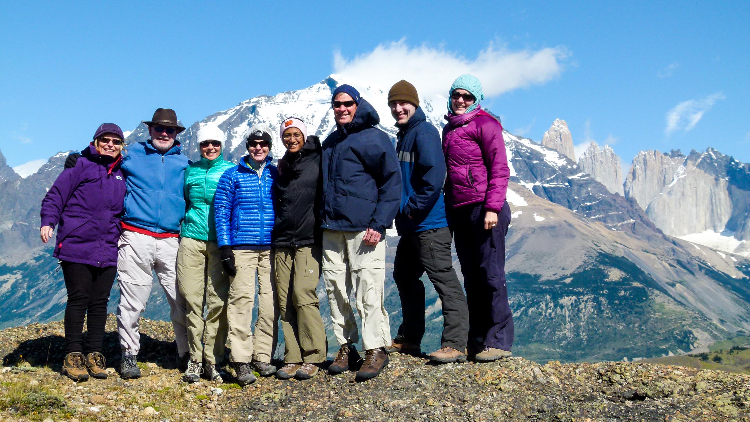 Group of travelers stand high in Chile mountains