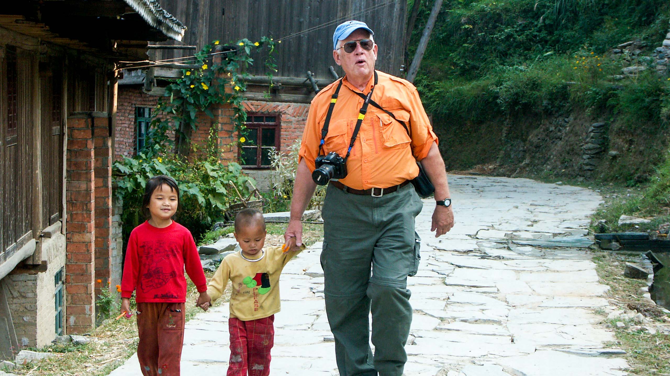 Traveler walks with young Chinese children