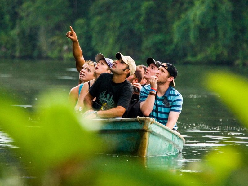 Group in boat points upward