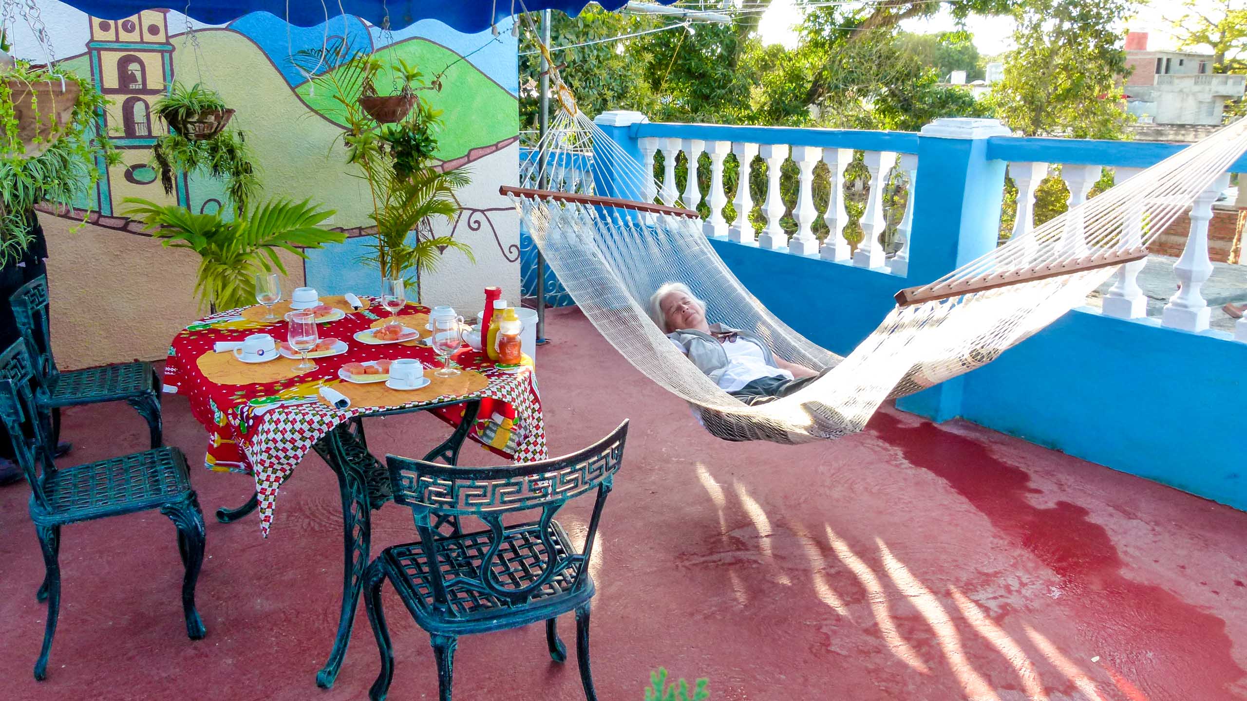 Woman rests in hammock in Cuba