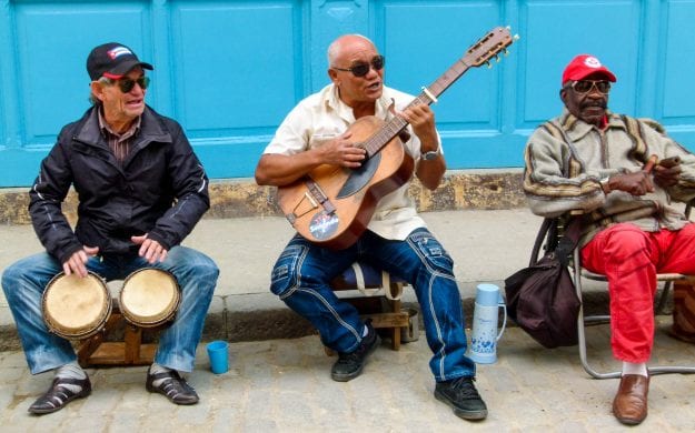 Men play instruments on Cuba street curb