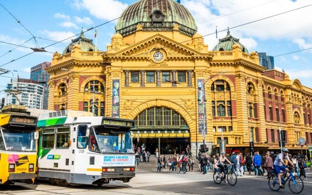 People and trains on Flinders Street in Melbourne, Australia