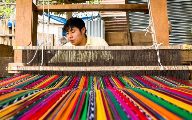 Man weaves colorful textiles in Guatemala