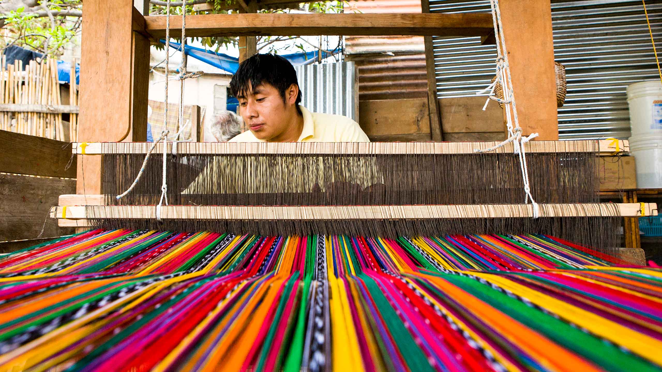 Man weaves colorful textiles in Guatemala