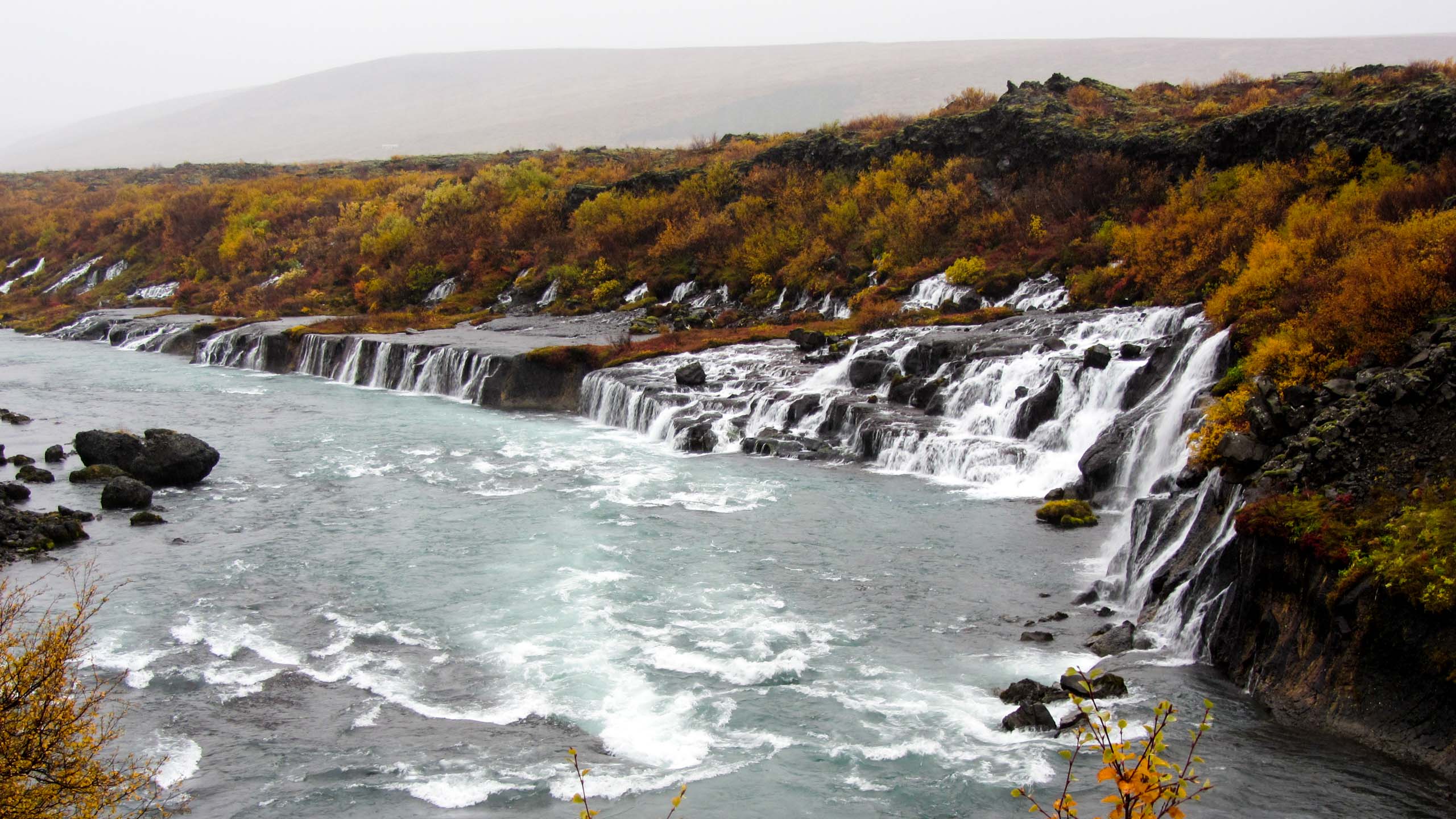 Small waterfalls run into an Iceland river