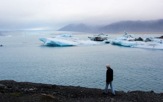 Traveler walks along Iceland shore