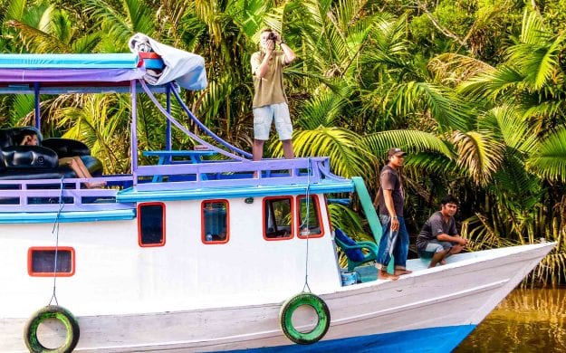 Traveler takes picture from Indonesia boat tour