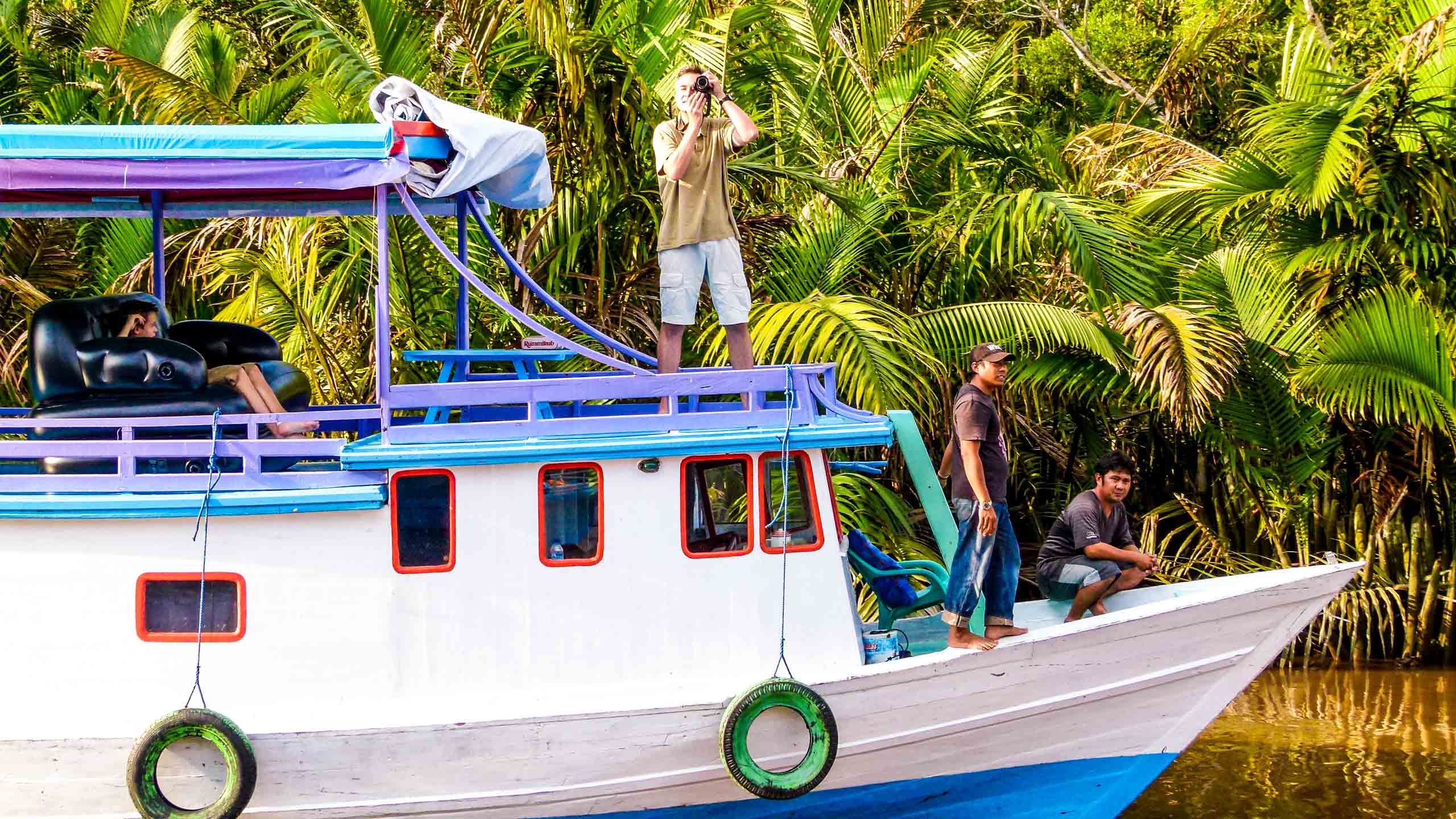 Traveler takes picture from Indonesia boat tour