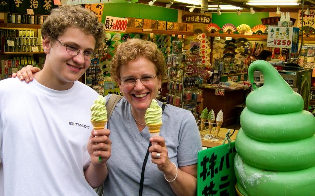 Teen boy and older woman hold ice cream cones