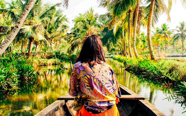 Woman boating down a river.