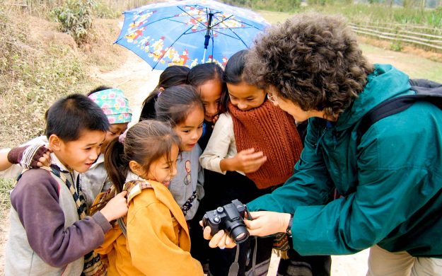 Group of Laos children look at traveler's camera