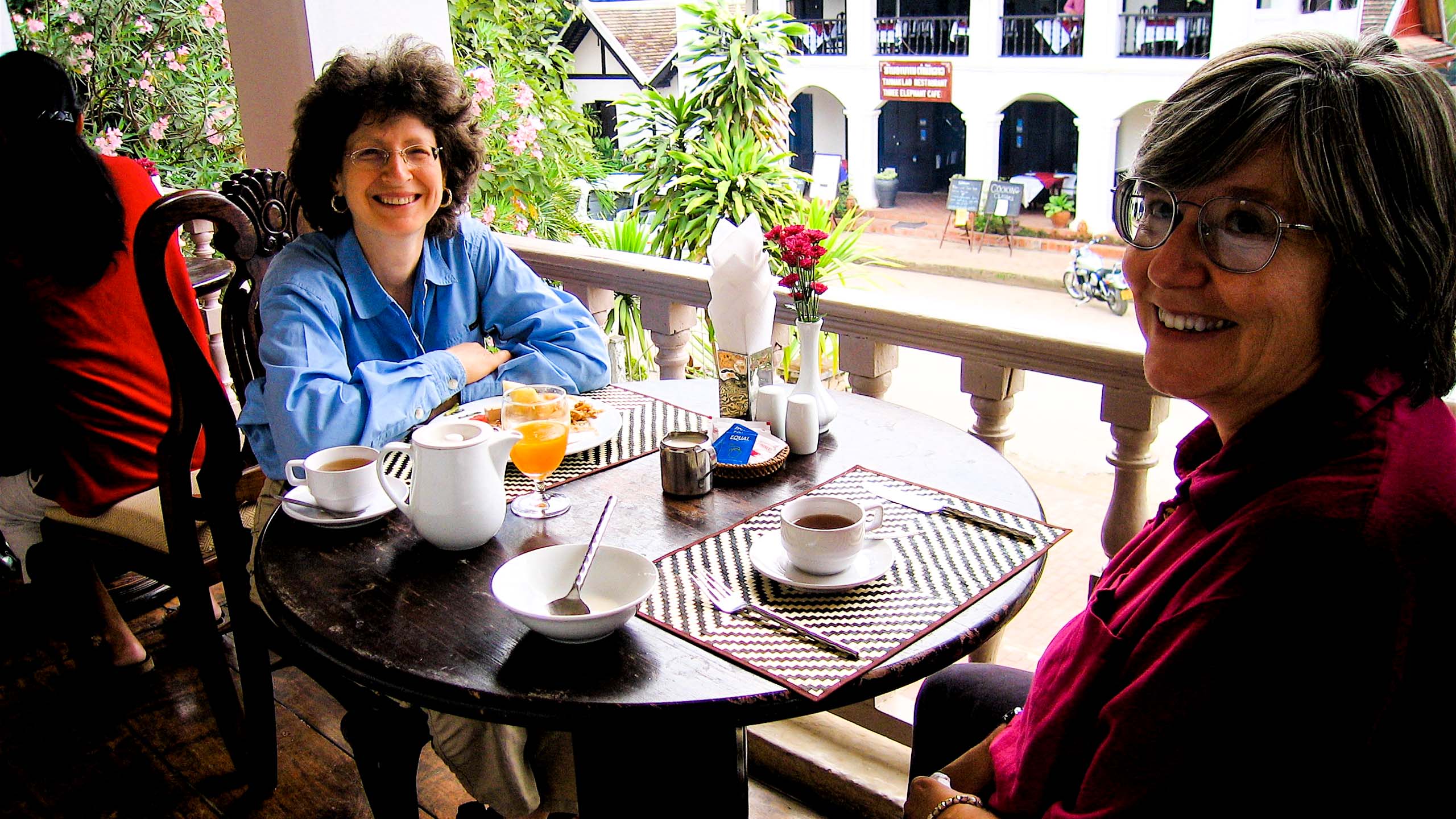 Two women enjoy a Laos cafe