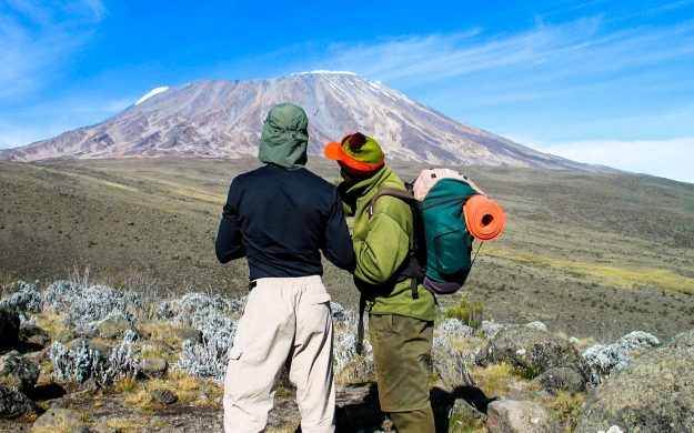 People look across Tanzania toward Mt Kilimanjaro