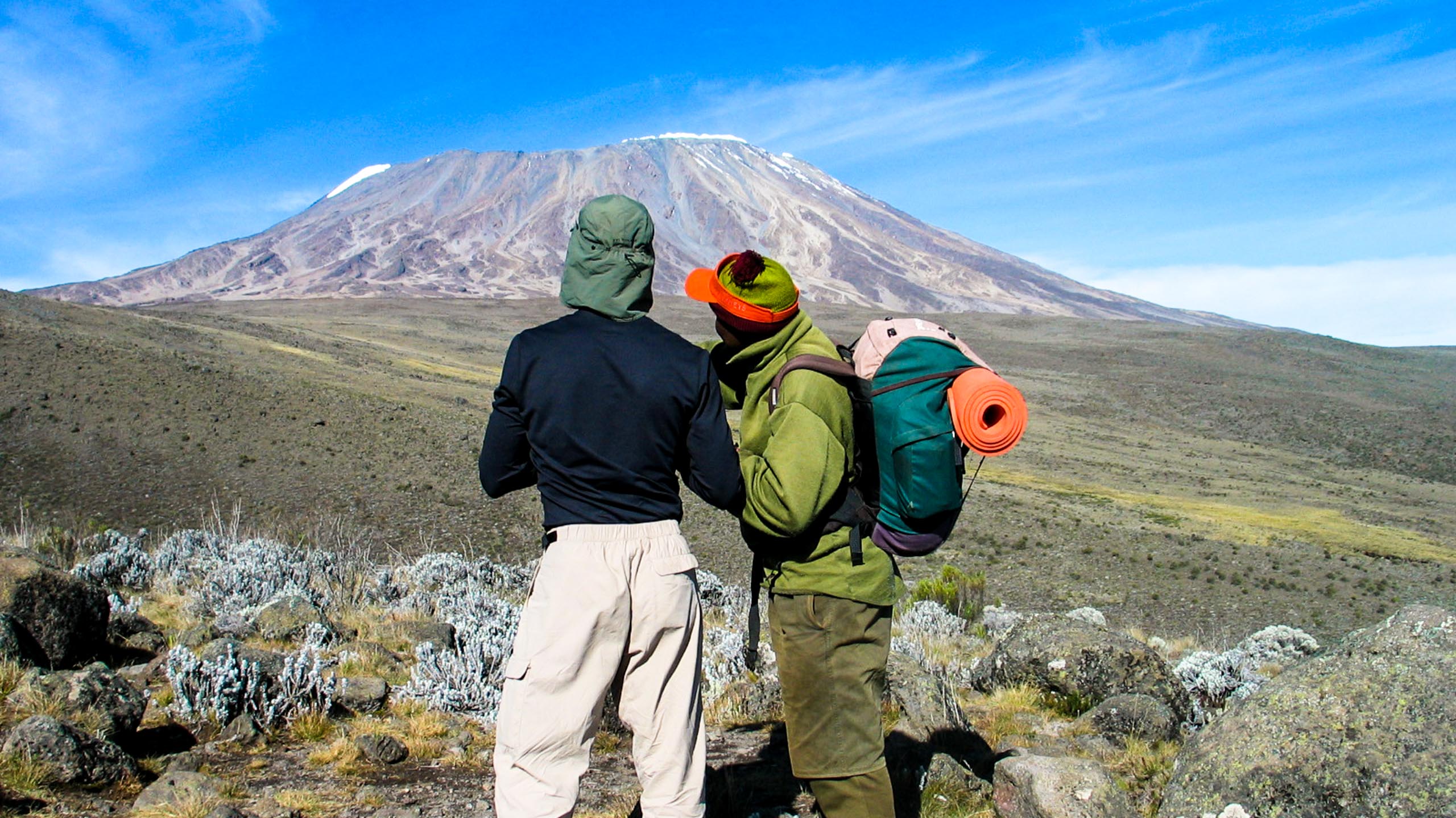 People look across Tanzania toward Mt Kilimanjaro