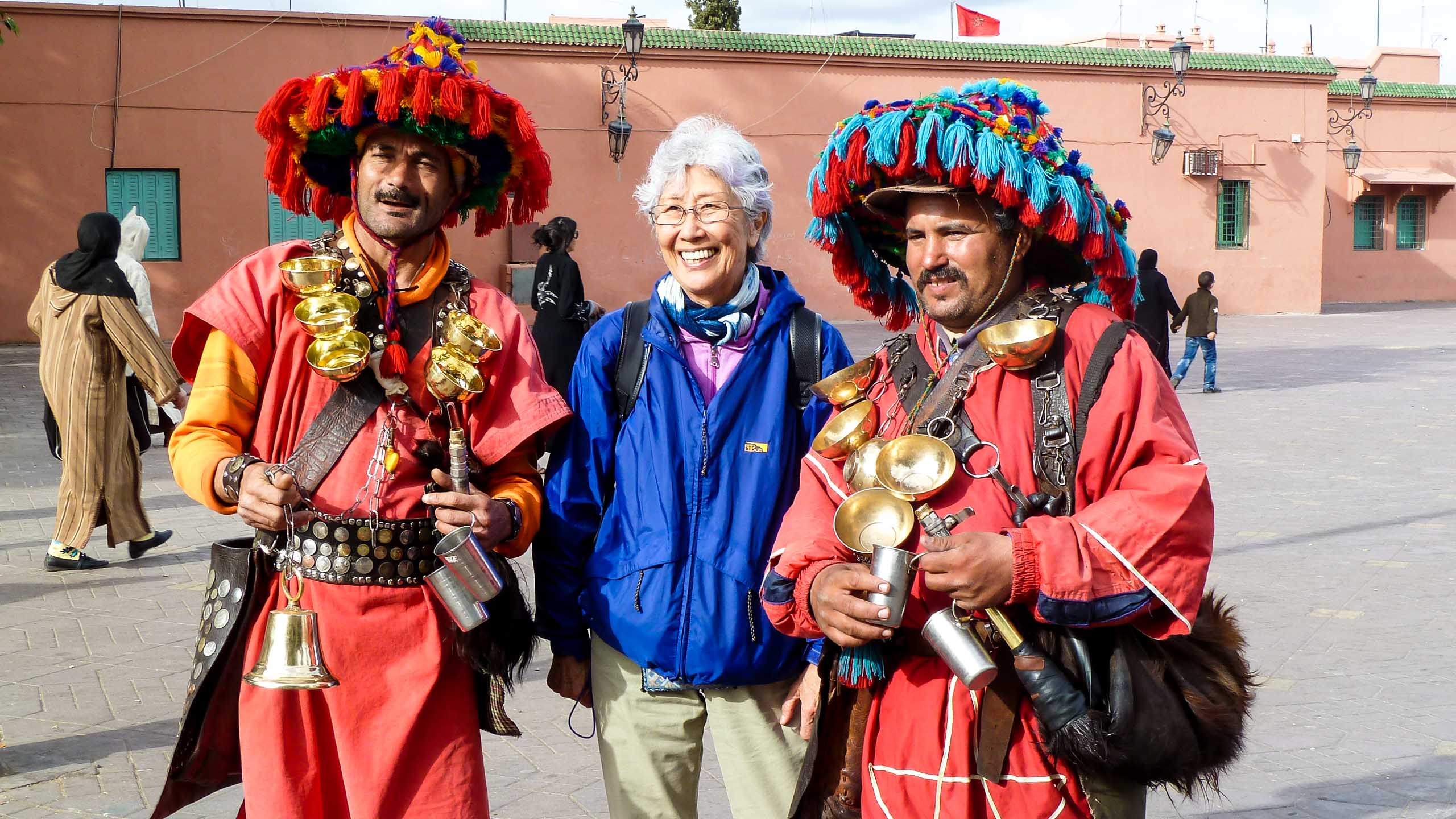 Woman stands with performers in Morocco