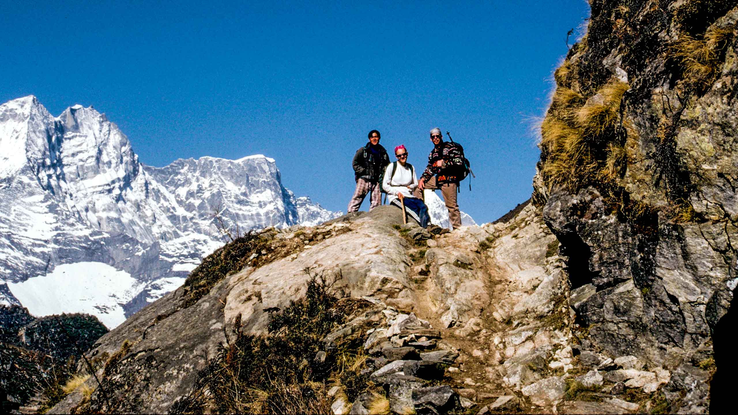 Everest hiking group rests on rock outcrop