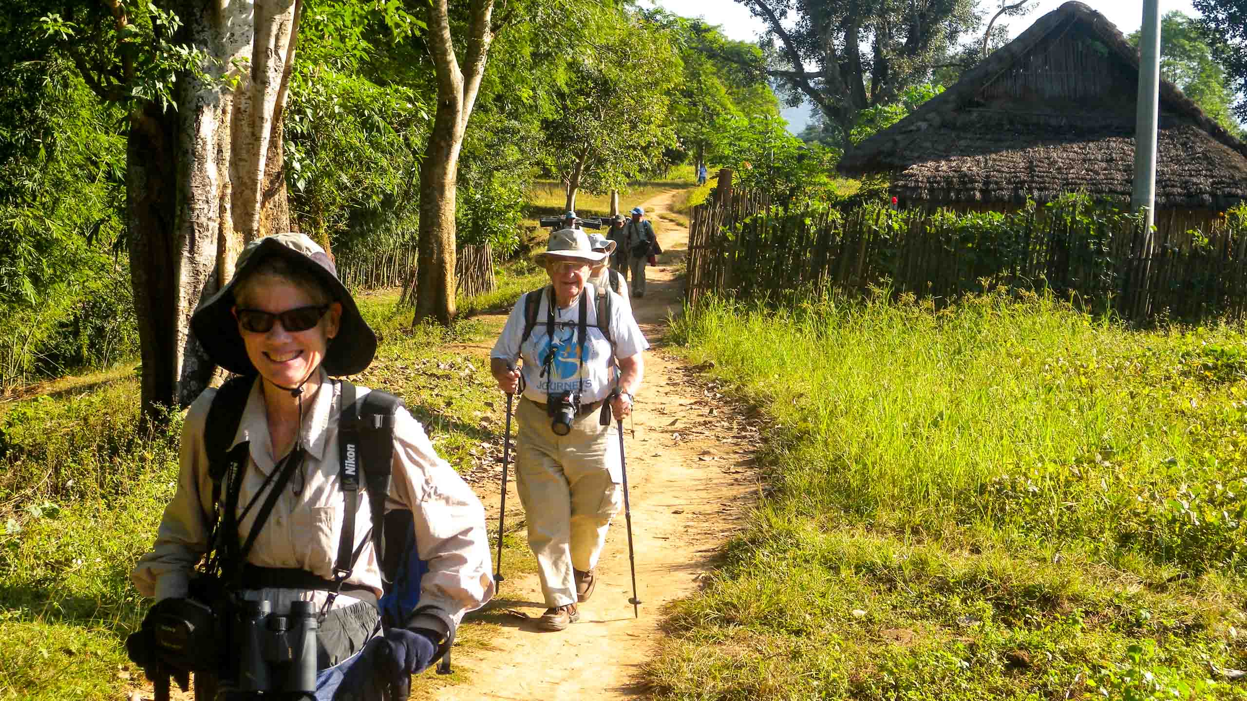 Travel group hikes through Nepal field