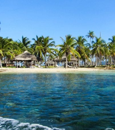 Panama beach with huts and palm trees