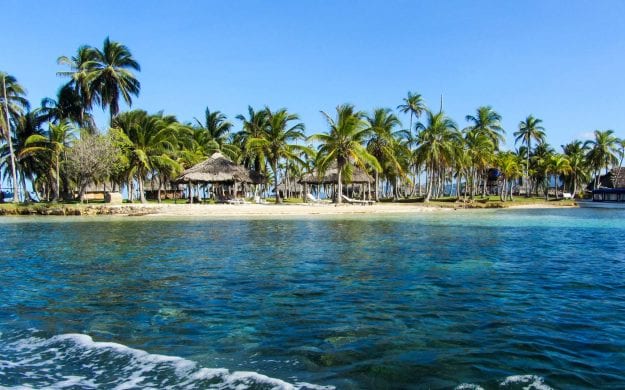 Panama beach with huts and palm trees