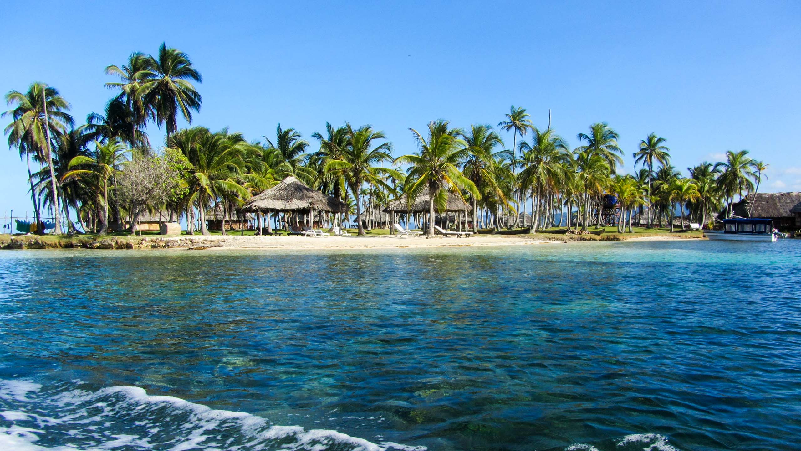 Panama beach with huts and palm trees