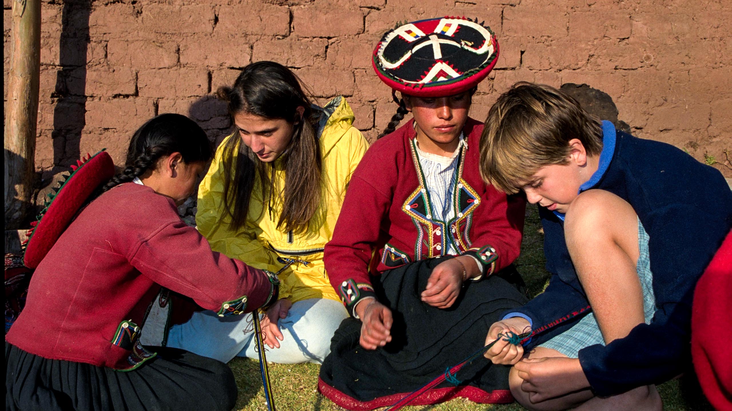 Kids make bracelets in Peru