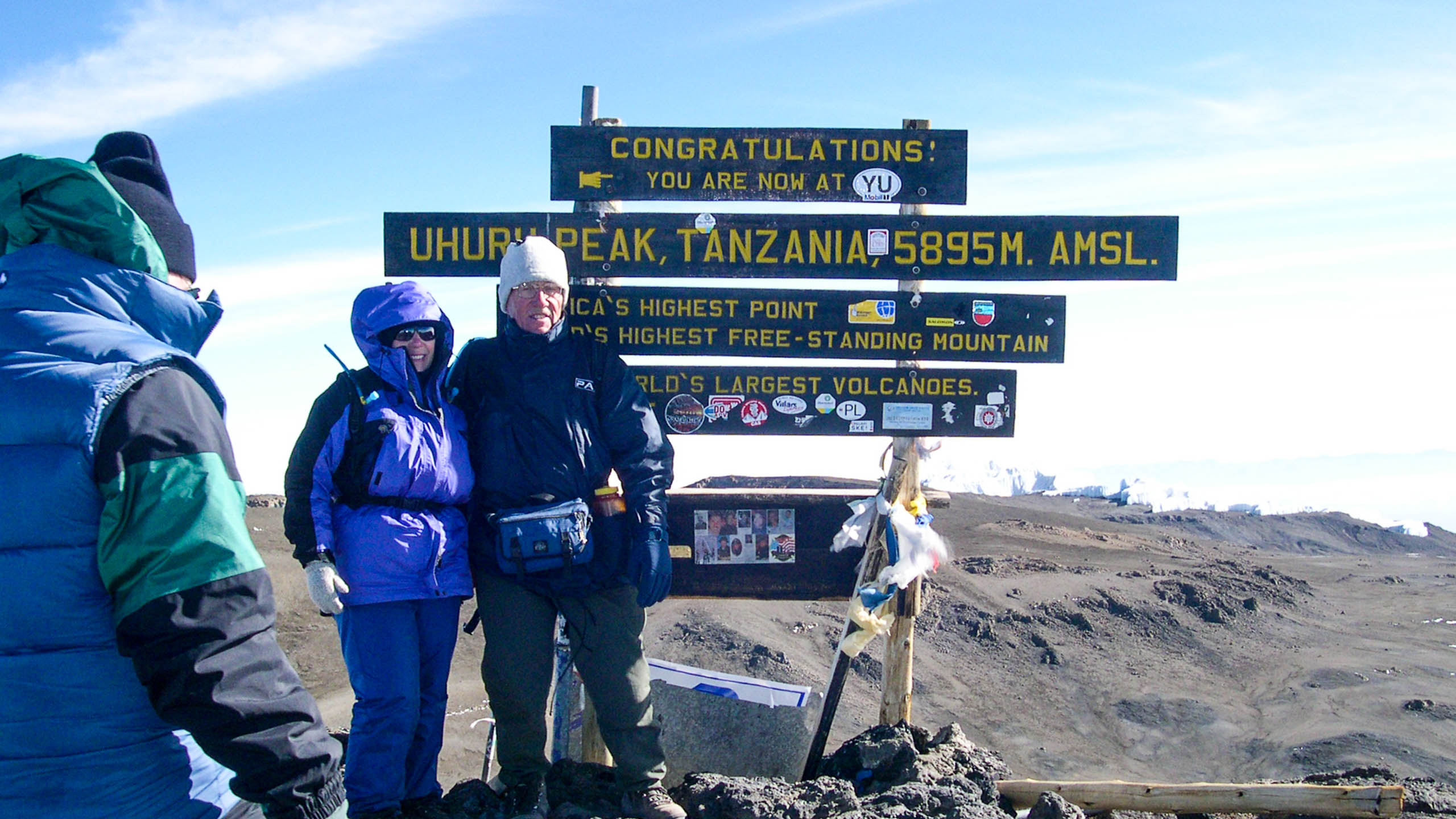 Hikers stand at top of Mt Kilimanjaro