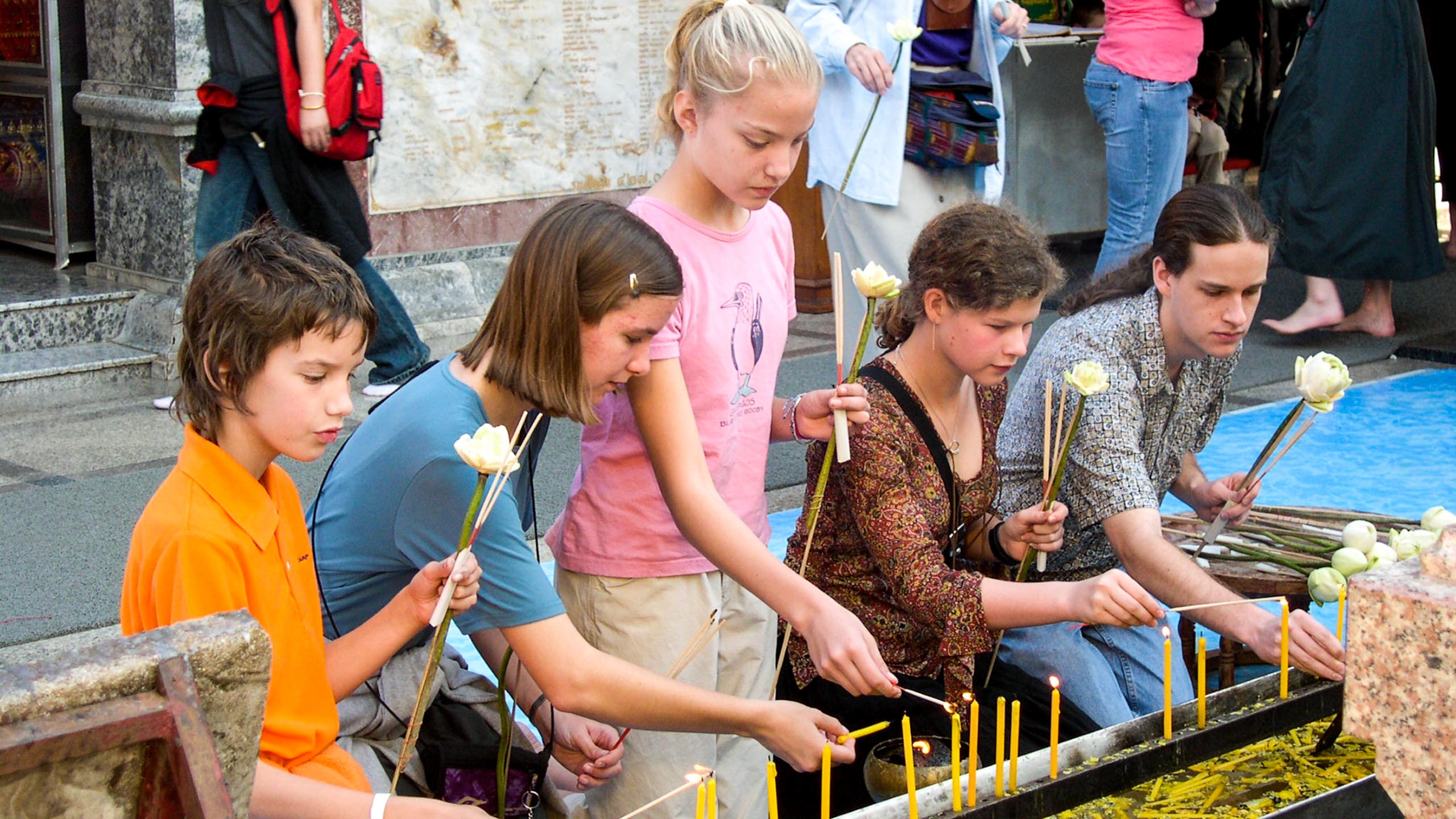 Kids light candles at Thailand temple