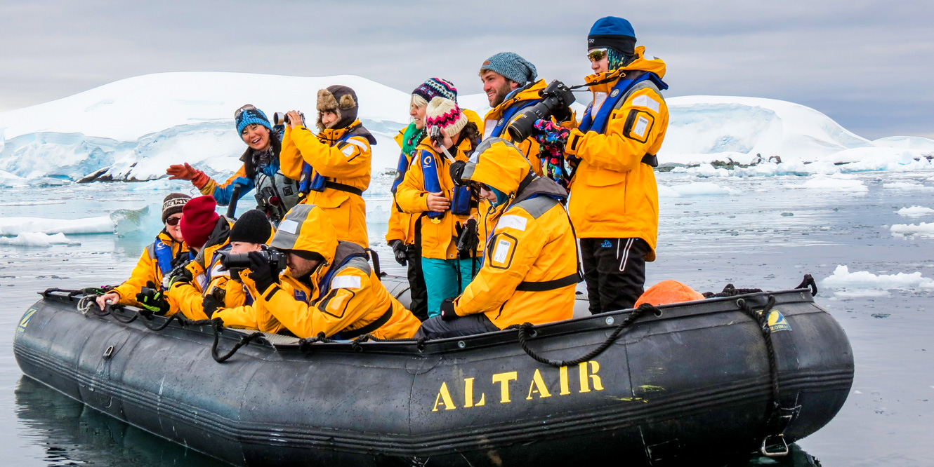 Tour group takes photo from raft in Antarctica