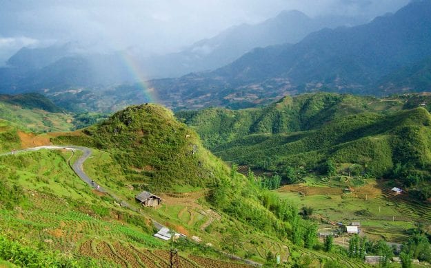 Rainbow over green Vietnam valley